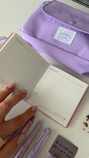 Open notebook from the Essential Purple Stationery Bundle with to-do list pages and a lavender pencil pouch