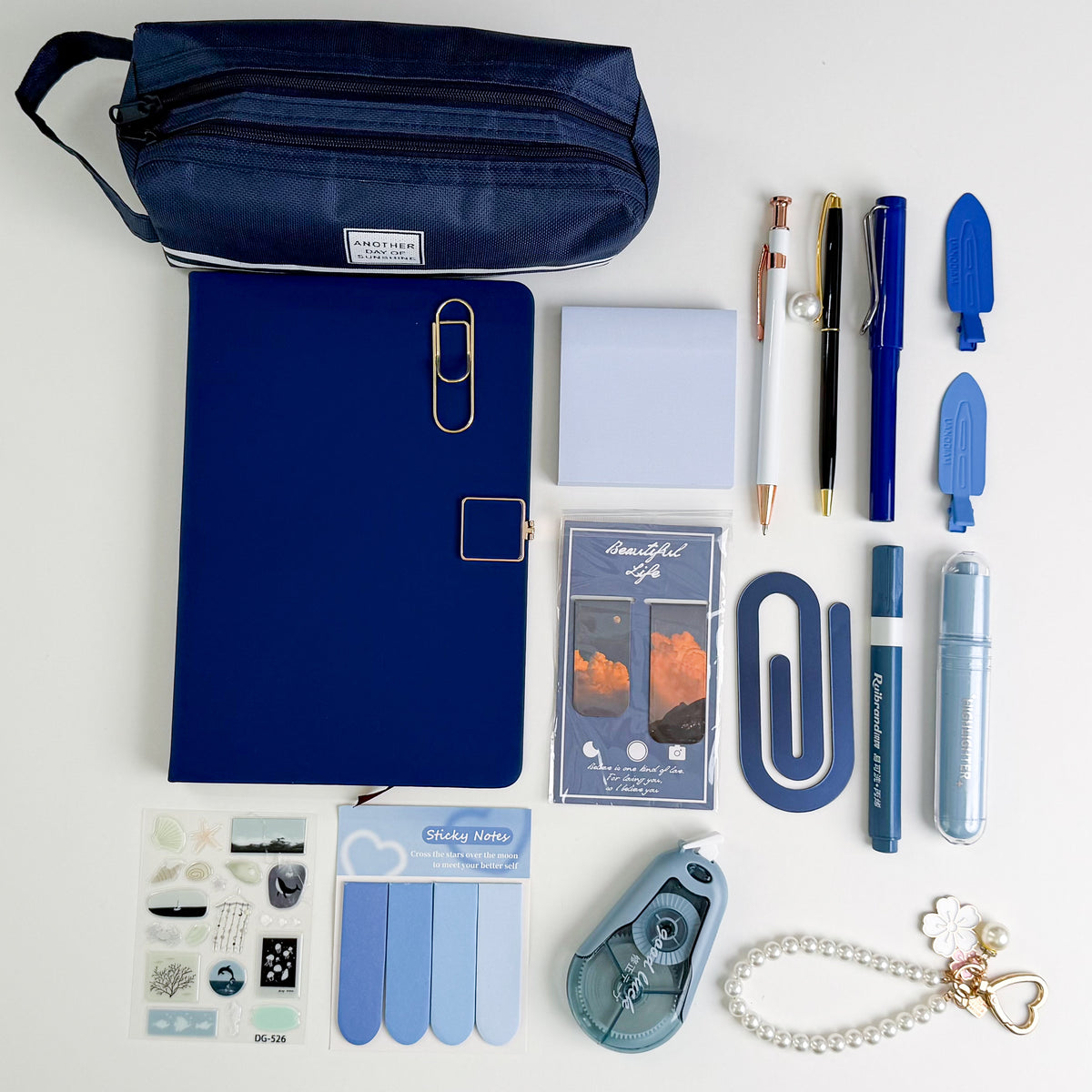 Blue stationery gift bundle with notebook, pencil pouch, pens, sticky notes, bookmarks and bookish accessories.