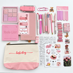 Bestie Pink Journaling Stationery Set with canvas pouch, pink notebooks, pens, sticky notes, reading light, bookmarks and stickers on a white background.