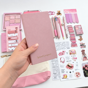 Pink A6 lined notebook with Splendid Prospects gold lettering, shown with coordinating pens, stickers and stationery accessories.