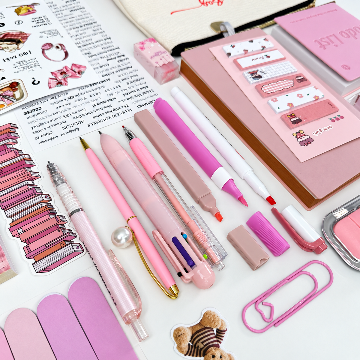 21-piece pink stationery gift bundle featuring a Bestie canvas pouch, to-do notebook, A6 journal, colorful pens, sticky notes and cute bookish accessories.