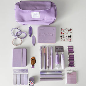 Purple Stationery Gift Bundle featuring a premium purple pencil pouch, notebook, gel pens, mechanical pencil, highlighters, sticky notes, bookmarks, stickers, correction tape, hair accessories, and cute desk accessories for book lovers and journaling.