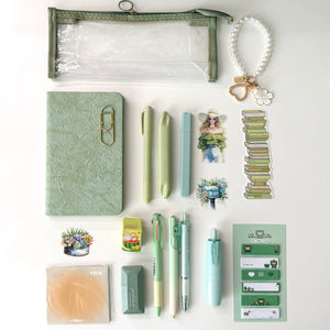 Green Stationery Gift Bundle with clear sage pencil pouch, notebook journal, pens, mechanical pencil, sticky notes, correction tape, stickers, bookmark, keychain, and aesthetic desk accessories for book lovers and journaling.