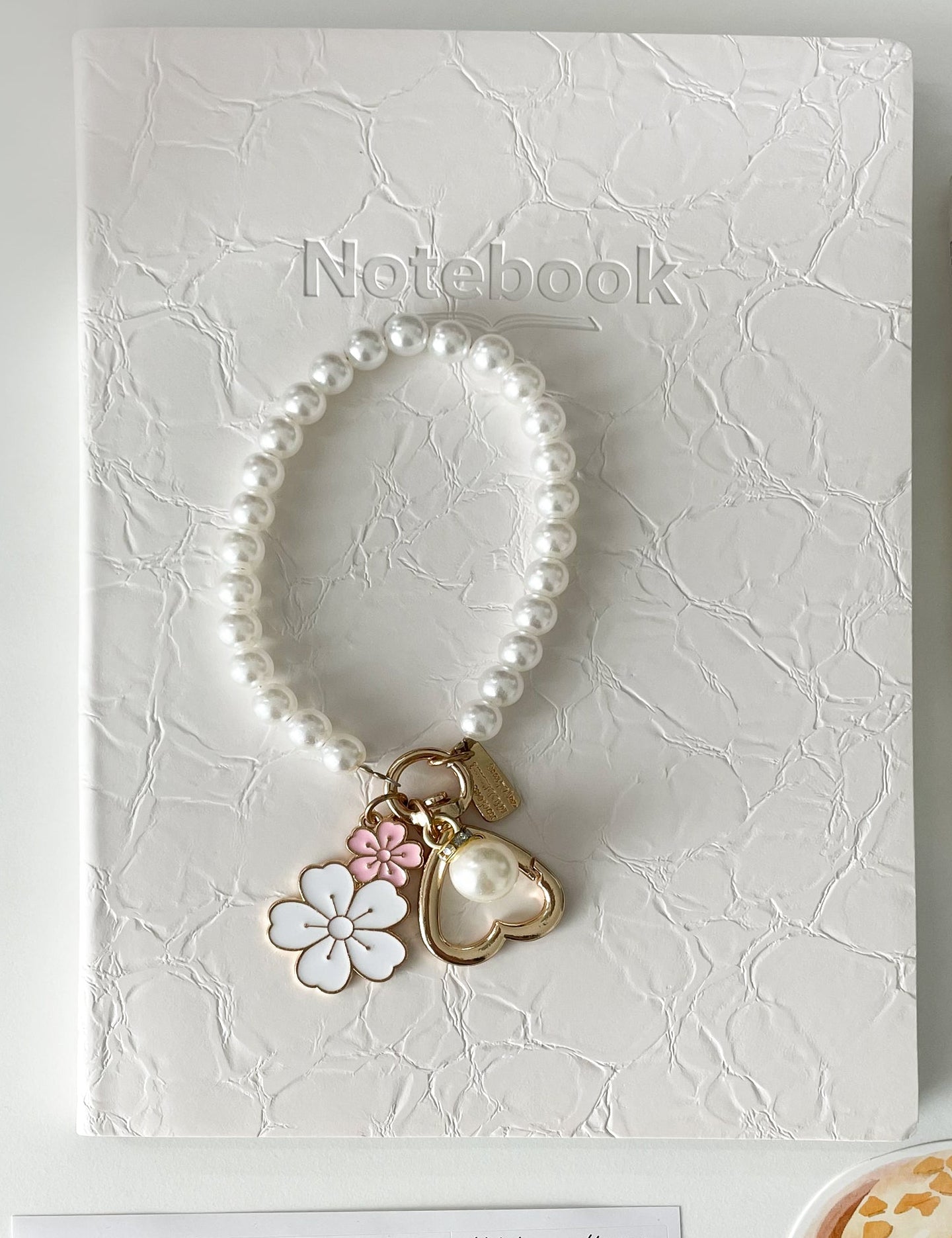 Cream aesthetic notebook paired with a pearl keychain charm from the Morning Coffee Stationery Gift Bundle for book lovers, journaling, and cozy stationery collections.