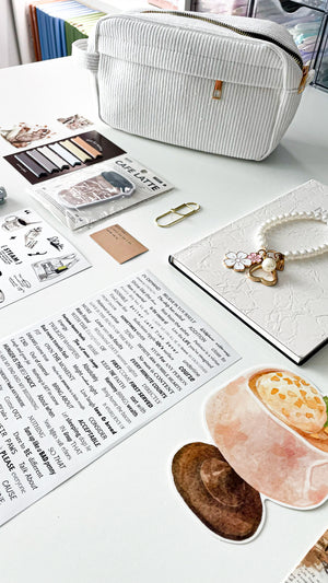 Lifestyle photo of the Morning Coffee Stationery Gift Bundle featuring a cream corduroy pencil pouch, cream notebook, pearl keychain, coffee-themed stationery, bookmarks, sticky notes, and journaling accessories.