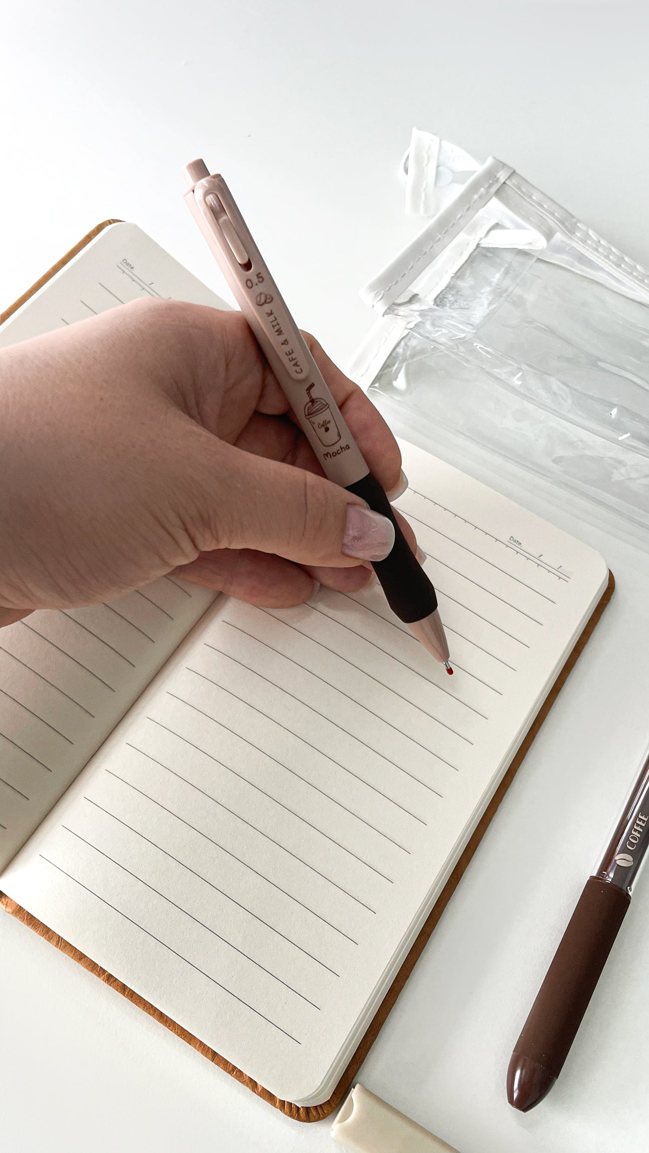 Writing in an A6 notebook with a coffee gel pen from a basic coffee stationery gift bundle.
