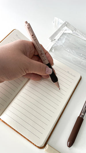 Writing in an A6 notebook with a coffee gel pen from a basic coffee stationery gift bundle.