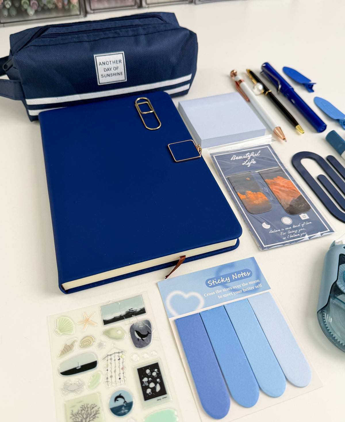 Blue aesthetic gift bundle with navy notebook, pencil pouch, pens, sticky notes, bookmarks and coordinated stationery accessories.