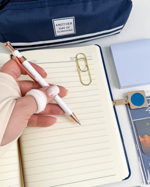 Blue stationery gift for journal lovers with lined notebook, elegant pen, pencil pouch, sticky notes and bookish accessories.