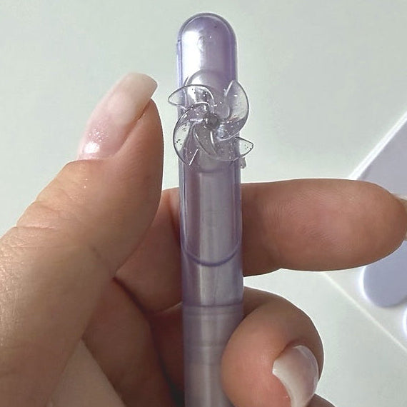 Close-up of a lavender gel pen with a flower topper from the Essential Purple Stationery Bundle