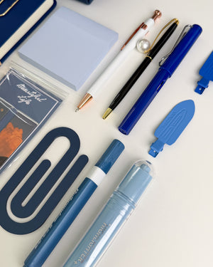 Navy blue stationery set with pens, highlighters, sticky notes, bookmarks and aesthetic accessories in coordinating blue shades.