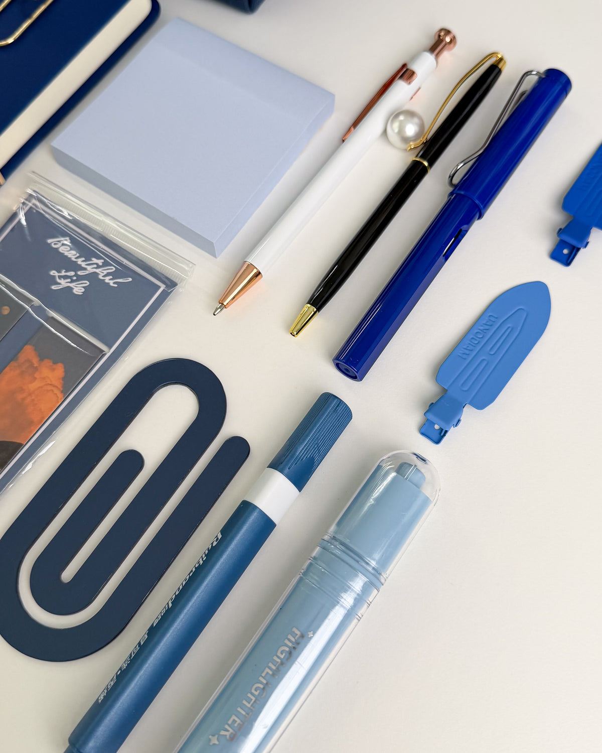 Navy blue stationery set with pens, highlighters, sticky notes, bookmarks and aesthetic accessories in coordinating blue shades.