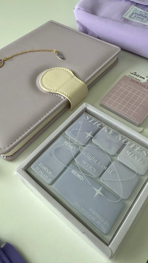 Close-up of a pastel notebook, sticky notes, and planning essentials from the Essential Purple Stationery Gift Box