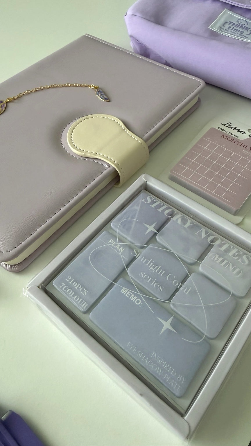Close-up of a pastel notebook, sticky notes, and planning essentials from the Essential Purple Stationery Gift Box