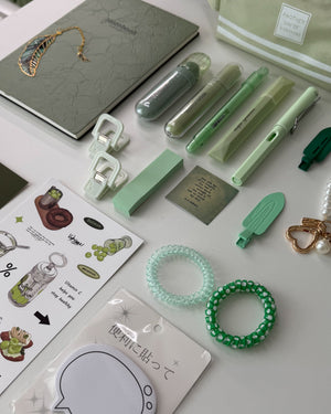 Sage Garden green stationery bundle with notebook, pens, highlighters, sticky notes, bookmarks, hair ties and bookish accessories.