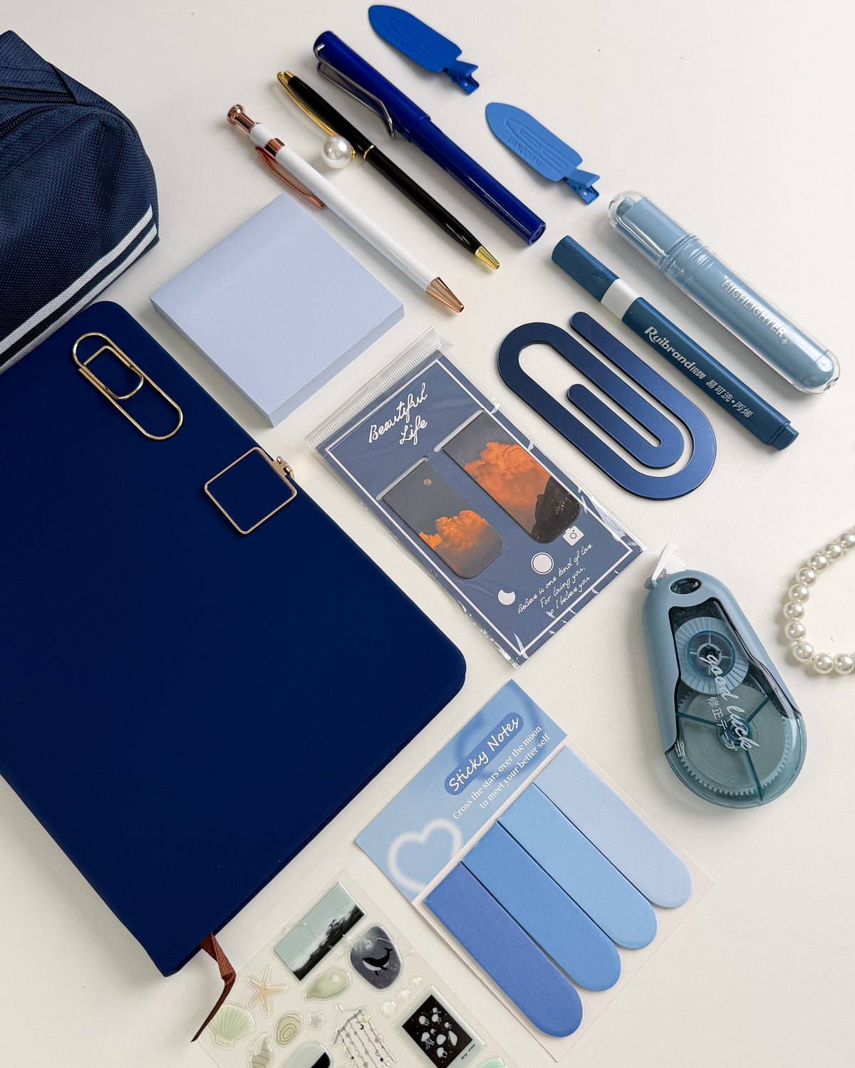Blue stationery gift bundle for stationery lovers with notebook, pens, sticky notes, bookmarks, highlighters and aesthetic accessories.